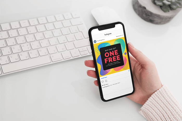 Mockup Featuring A Woman S Hand Holding An Iphone 11 Pro Over A Neat Desk