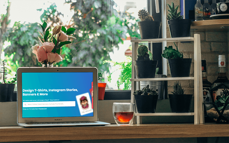 Mockup Of A Macbook Air Next To Some Plant Pots