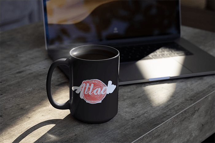 Mockup Of A Sticker On A Coffee Mug Beside A Laptop