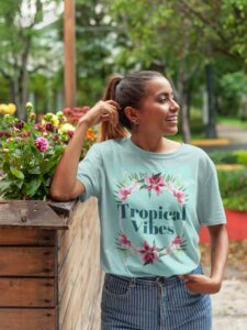 A Summer Mockup Tshirt Of A Smiling Girl Wearing A Tshirt Leaning Against Flowers