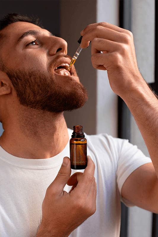 Dropper Bottle Mockup Of A Man Taking Cbd Oil