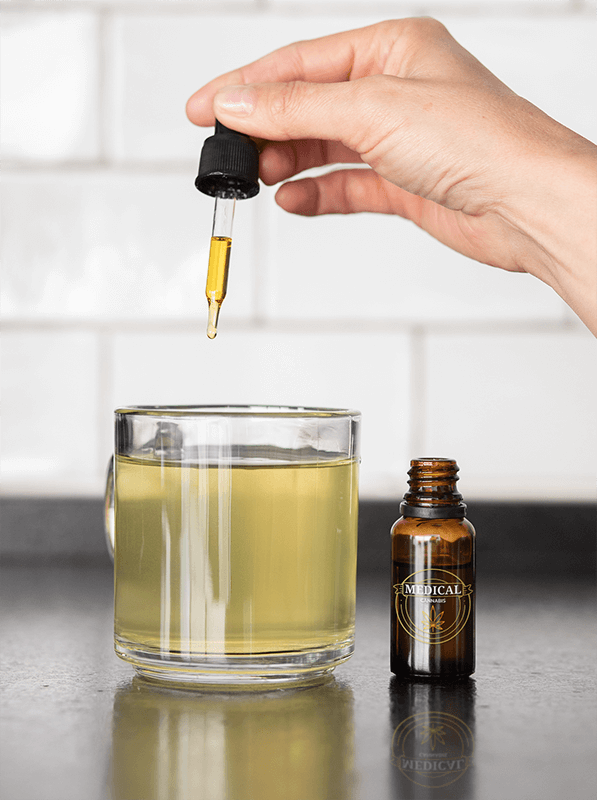 Dropper Mockup Featuring A Woman Adding Some Cbd Drops To Her Tea 32098