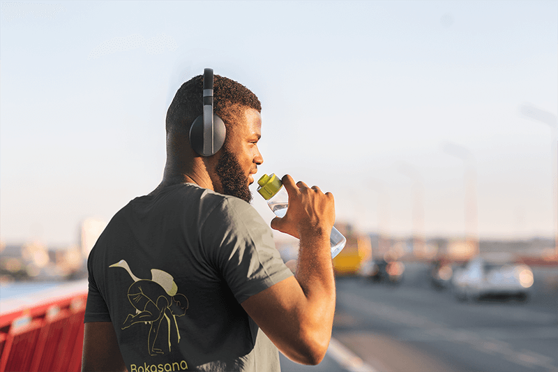 T Shirt Mockup Of The Back View Of A Runner Drinking Some Water