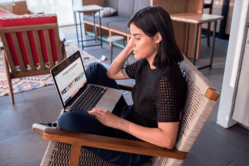 Girl Working With A Macbook Pro Mockup Sitting Outside