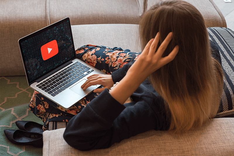 Macbook Mockup Of A Woman Working On A Sofa