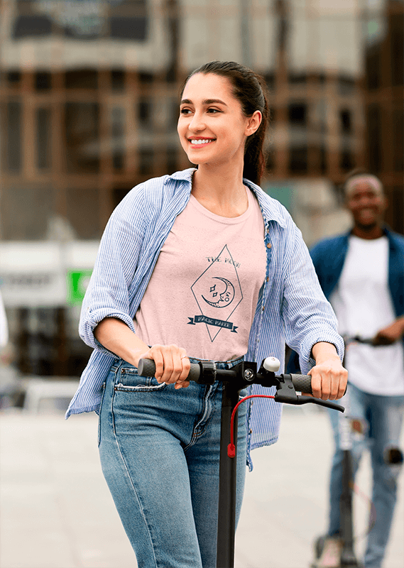 T Shirt Mockup Featuring A Young Woman Riding An Electric Scooter