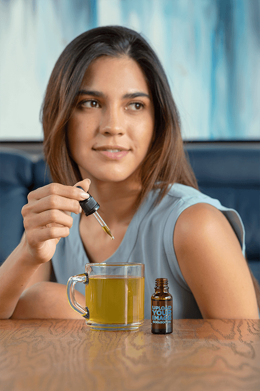 Dropper Mockup Of A Young Woman Adding Cbd Oil To Her Tea