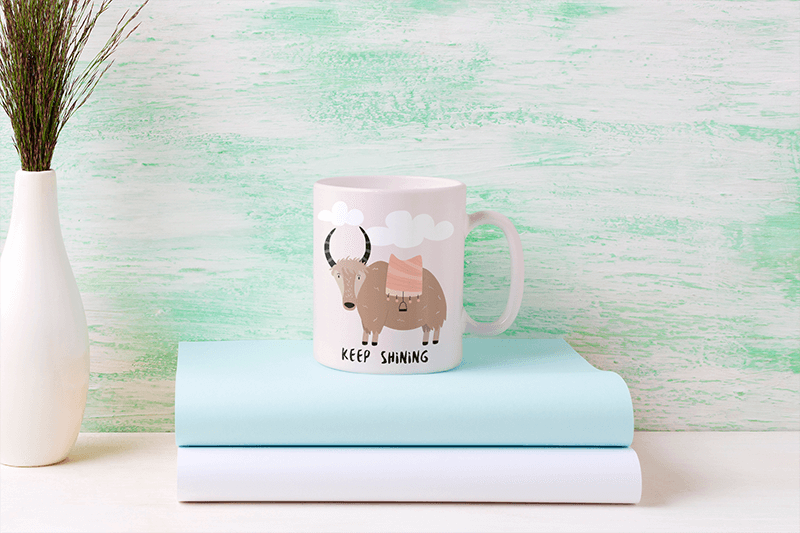 Mockup Of An 11 Oz Coffee Mug Placed On Top Of Some Books 43562 R El2