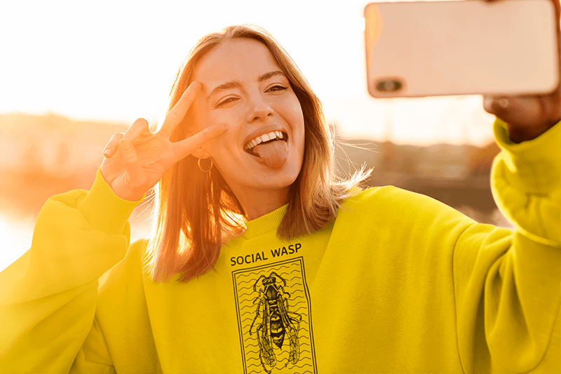 Selfie Mockup Of A Woman With A Sweatshirt Doing A Funny Face