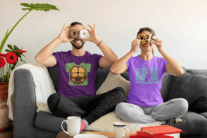 T Shirt Mockup Featuring A Fun Couple Putting Donuts On Their Eyes