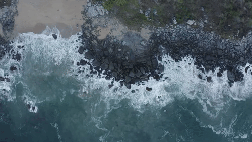Mixkit Top Aerial Shot Of Seashore With Rocks