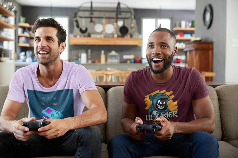 T Shirt Mockup Of Two Men Playing Video Games At Home