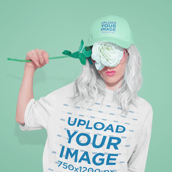 Mockup Of A Woman Wearing A Tee And A Cap While Covering Her Face With A Flower