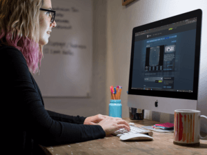 Girl Working In An Imac While Wearing Glasses At The Office