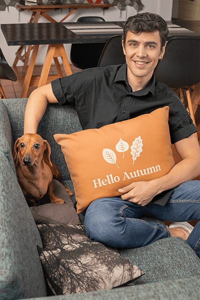 Mockup Of A Man Holding A Pillow While Petting A Dog