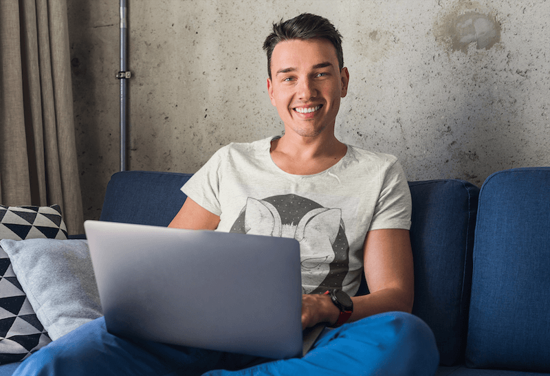 Mockup Of A Young Man Working From Home While Wearing A Heather Tee