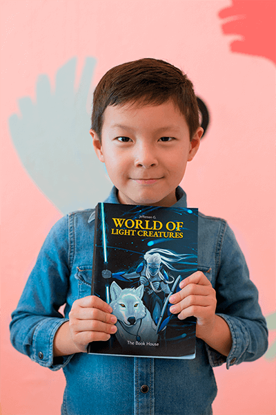 Book Mockup Of A Happy Kid Showing Off His Book