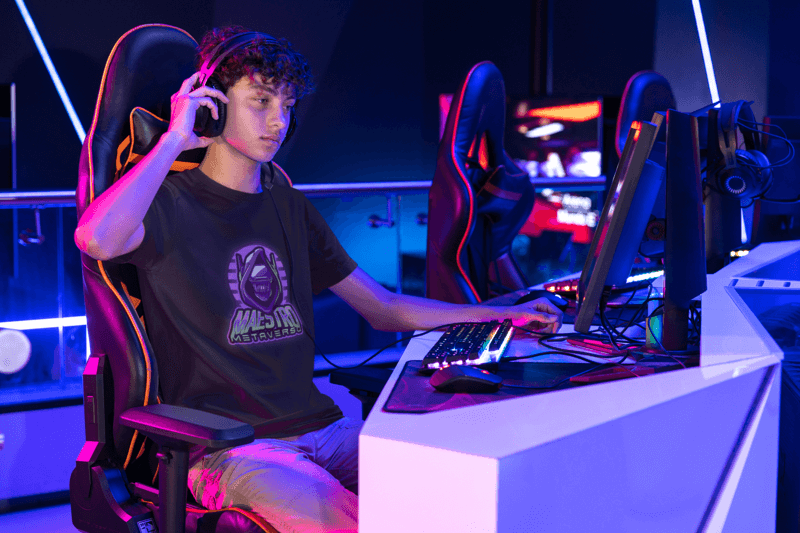 Bella Canvas T Shirt Mockup Featuring A Man At A Gaming Center M28523