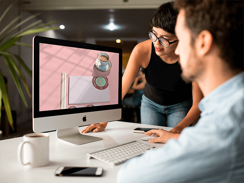 Girl Showing Something In Imac Mockup To Coworker
