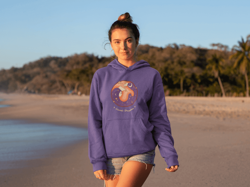Woman On A Beach Wearing A Hoodie Mockup Featuring A 70s Design