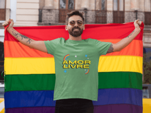 T Shirt Mockup Featuring A Proud Man Holding The Lgbt Flag