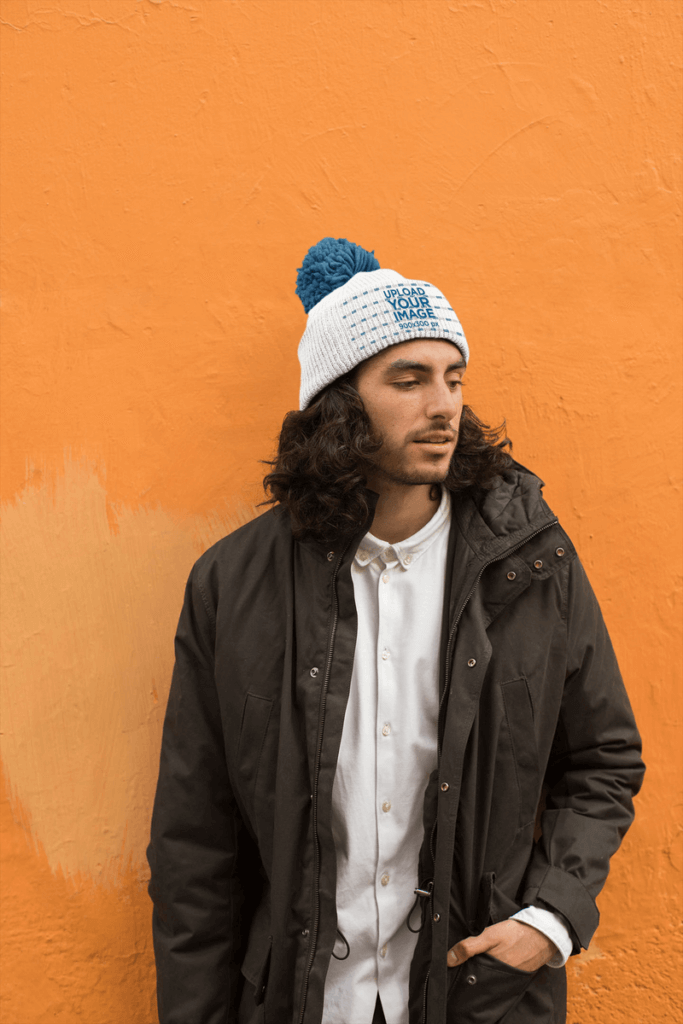 Man Posing Against A Wall While Wearing A Beanie Mockup