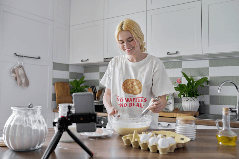 T Shirt Mockup Of A Woman Recording Herself Cooking