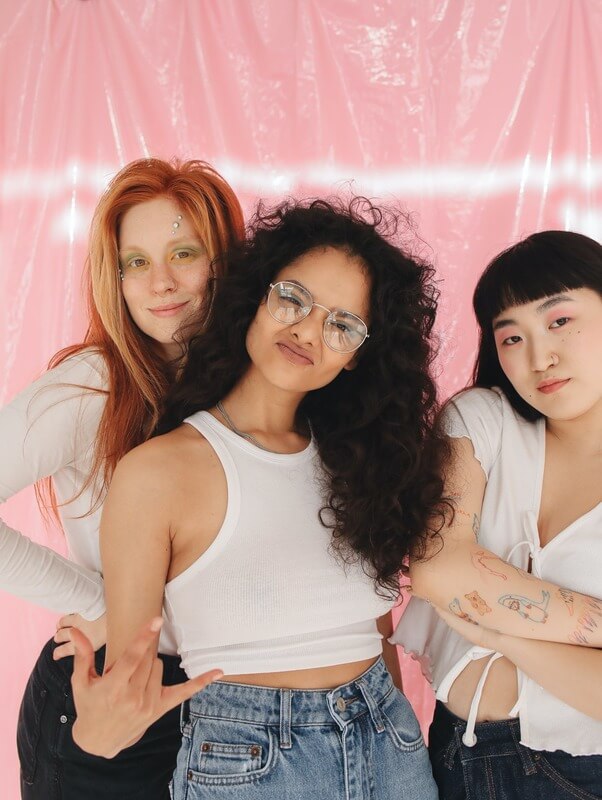Three Young Girls From Generation Z Who Belong To Different Ethnicities, Posing For A Picture And Making Cool Expressions