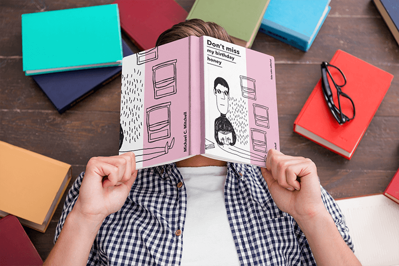 Mockup Of A Man Hiding His Face Behind A Book