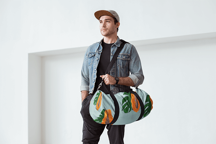 Gym Bag Mockup Featuring A Handsome Man Carrying A Duffel Bag