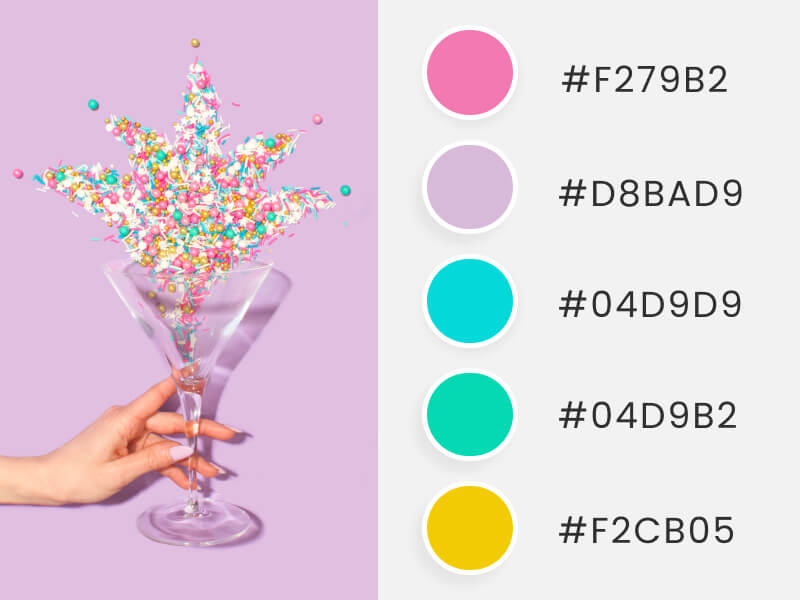 Winter Color Palettes - a woman's hand holding a glass while sparking colored bubbles