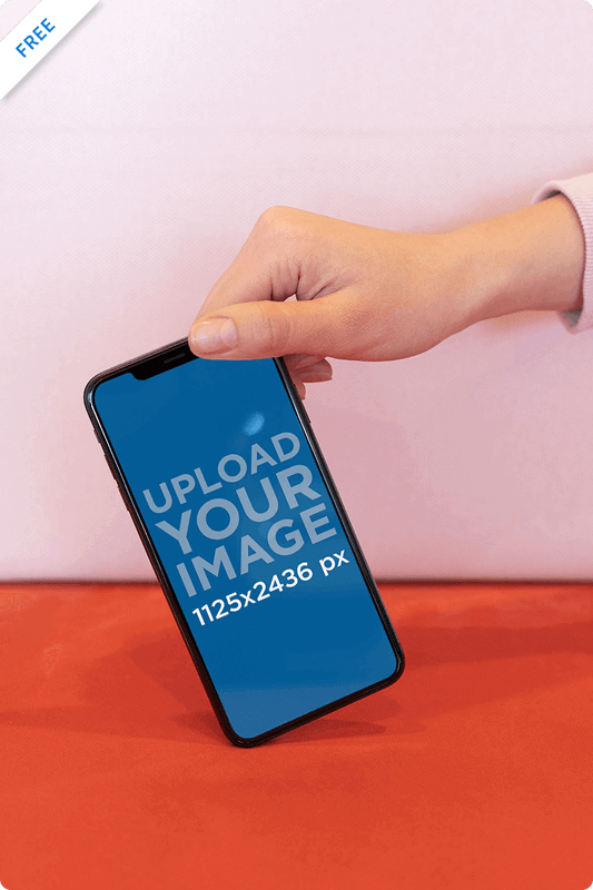 Mockup Featuring A Hand Holding An Iphone Xs By The Upper Corner