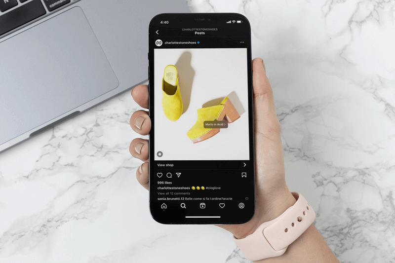 Mockup Of A Woman Holding An Iphone 12 Pro Max And Shopping On Instagram