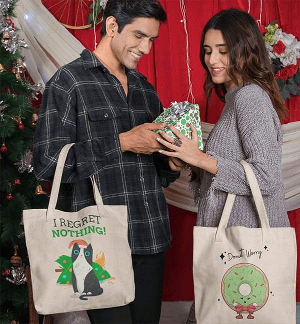 Tote Bag Mockup Featuring A Happy Couple Giving Each Other A Christmas Present
