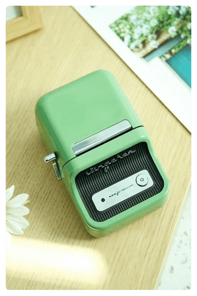 An Aesthetic Retro Style Green Mini Printer On A Wooden Surface As One Of The Best Dropshipping Products For 2024