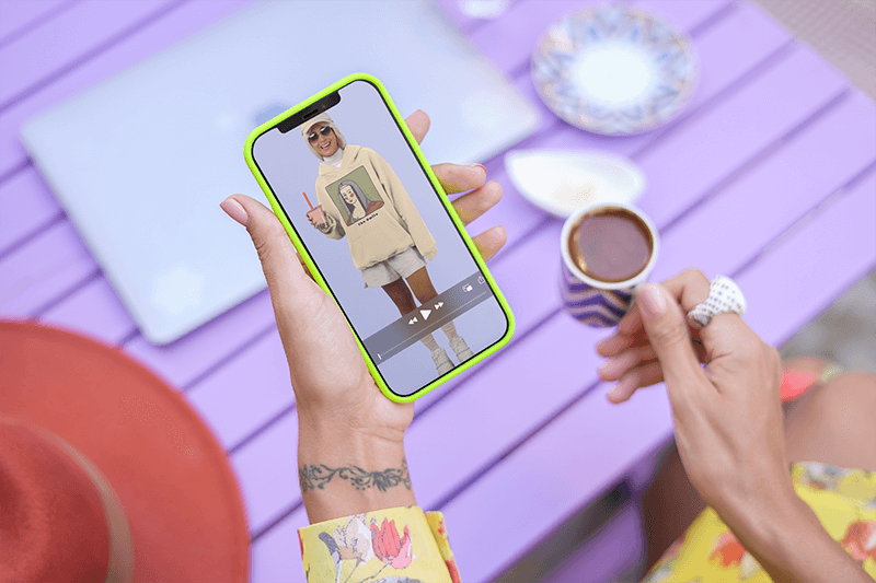 Digital Mockup Of A Woman With A Wrist Tattoo Holding An Iphone 12