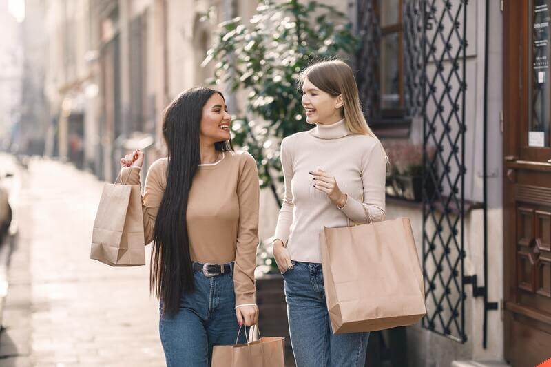 Two Happy Young Woman Making Their Black Friday Purchases