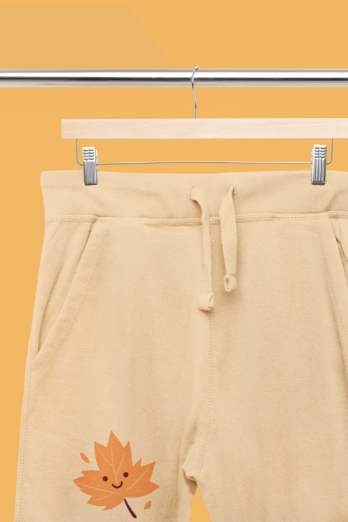 Mockup Of A Pair Of Sweatpants Placed On A Wooden Hanger With A Customizable Surface M33405