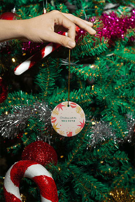 Christmas Themed Mockup Of A Person Holding A Ceramic Ornament