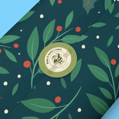 Mockup Of A Circular Santa Design Sticker With Wrapping Paper