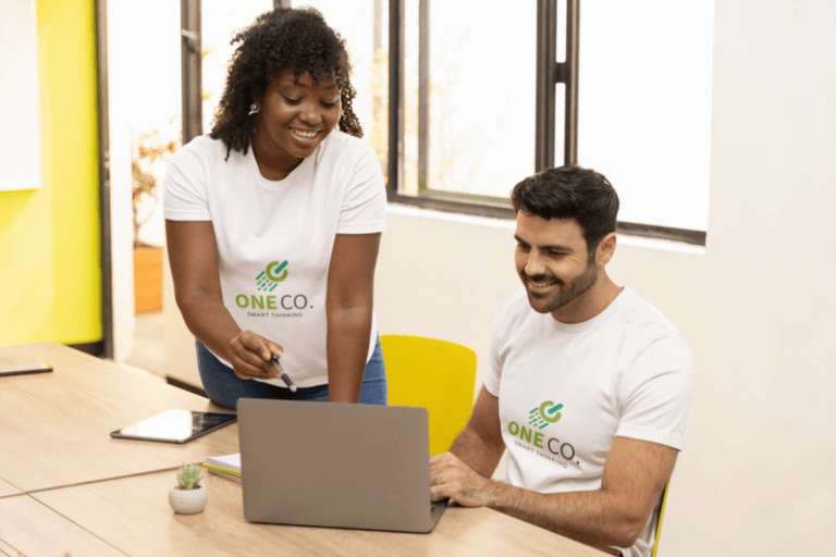 Bella Canvas T Shirt Mockup Of Two Coworkers Using A Laptop In The Office - How To Use Your Logo