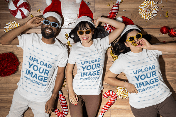 Christmas Themed T Shirt Mockup Featuring A Group Of Friends Lying On The Floor Together