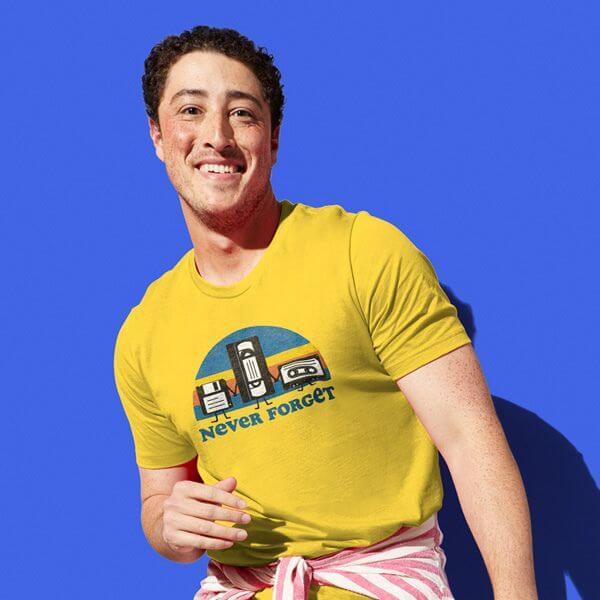 A Young Man Smiling Wearing A Yellow T Shirt With A Retro Design