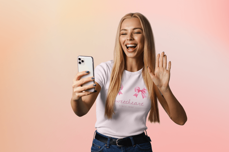 Round Neck T Shirt Mockup Featuring A Cheerful Woman Taking A Selfie In A Studio