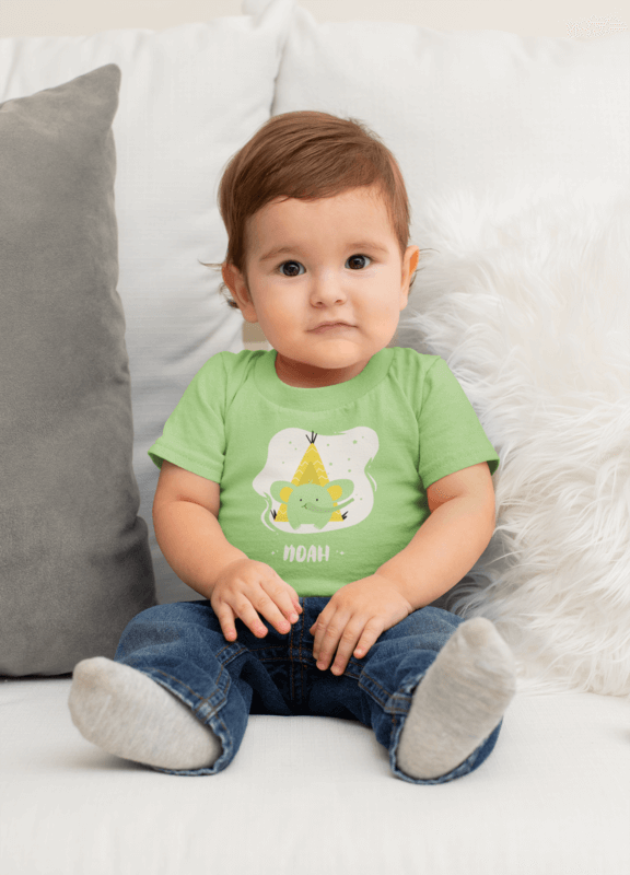 T Shirt Mockup Featuring A Cute Baby Boy Sitting On A Couch