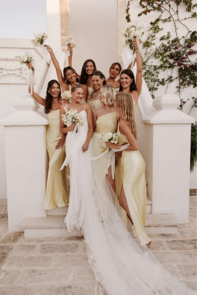 A Beautiful Young Bride Happily Posing With Her Bridesmaids, All Wearing Lovely Yellow Dresses