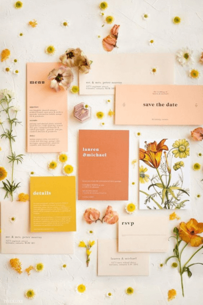 A Colorful Set Of Wedding Invitations In Warm Colors Reflecting Spring