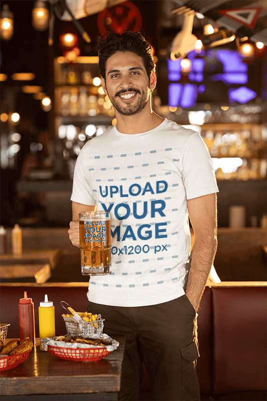Bella Canvas Tee Mockup Of A Smiling Bearded Man Holding A Beer Glass In A Bar