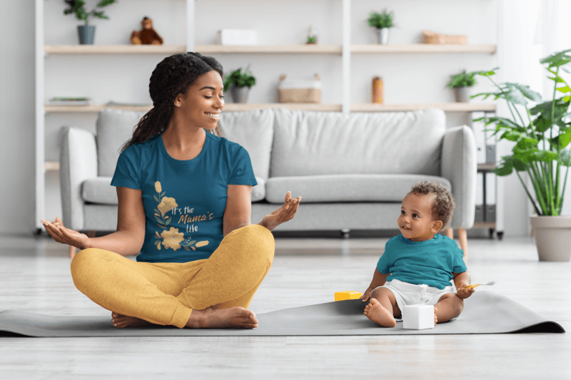 Mockup Of A Woman Wearing A T Shirt And Meditating With Her Baby At Home