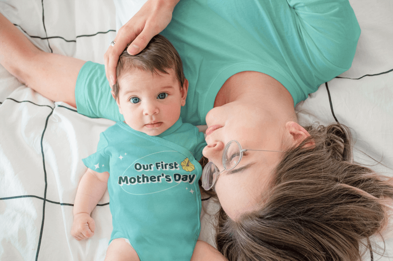 Sublimated Onesie Mockup Of A Baby Boy Lying In Bed With Her Mom